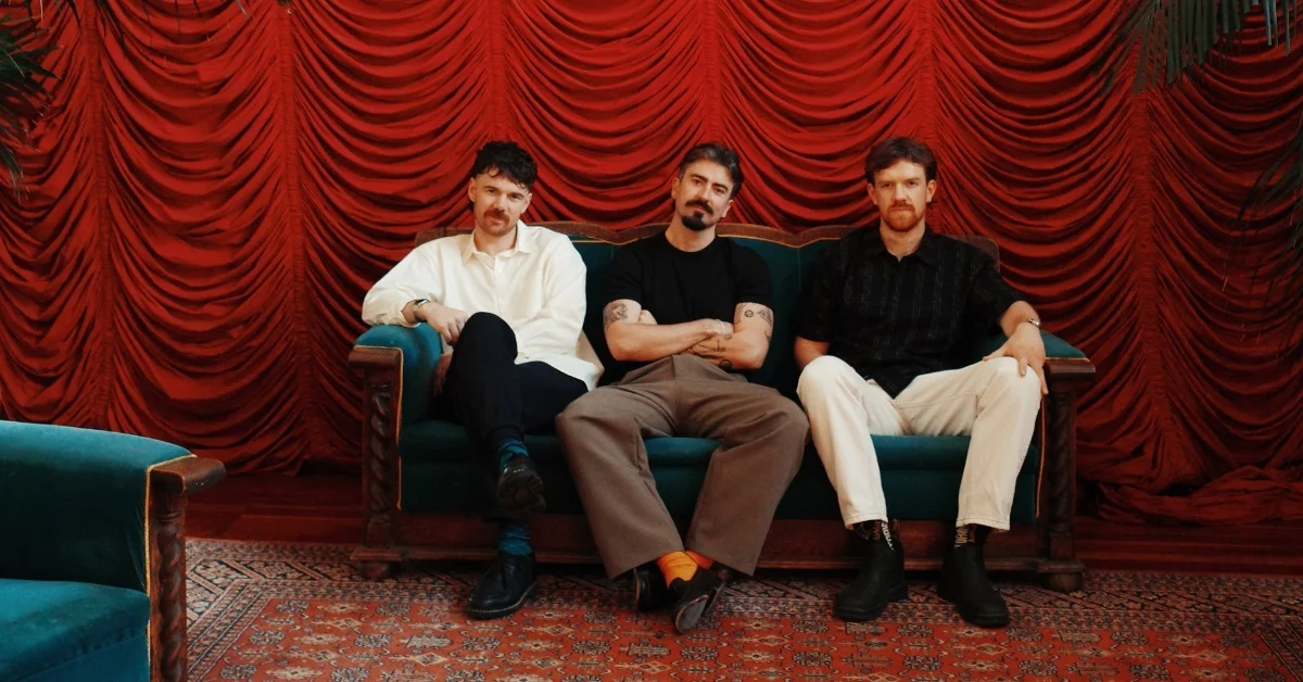 Official venue-provided promotional photograph of Amble seated on a couch; not the upcoming show.