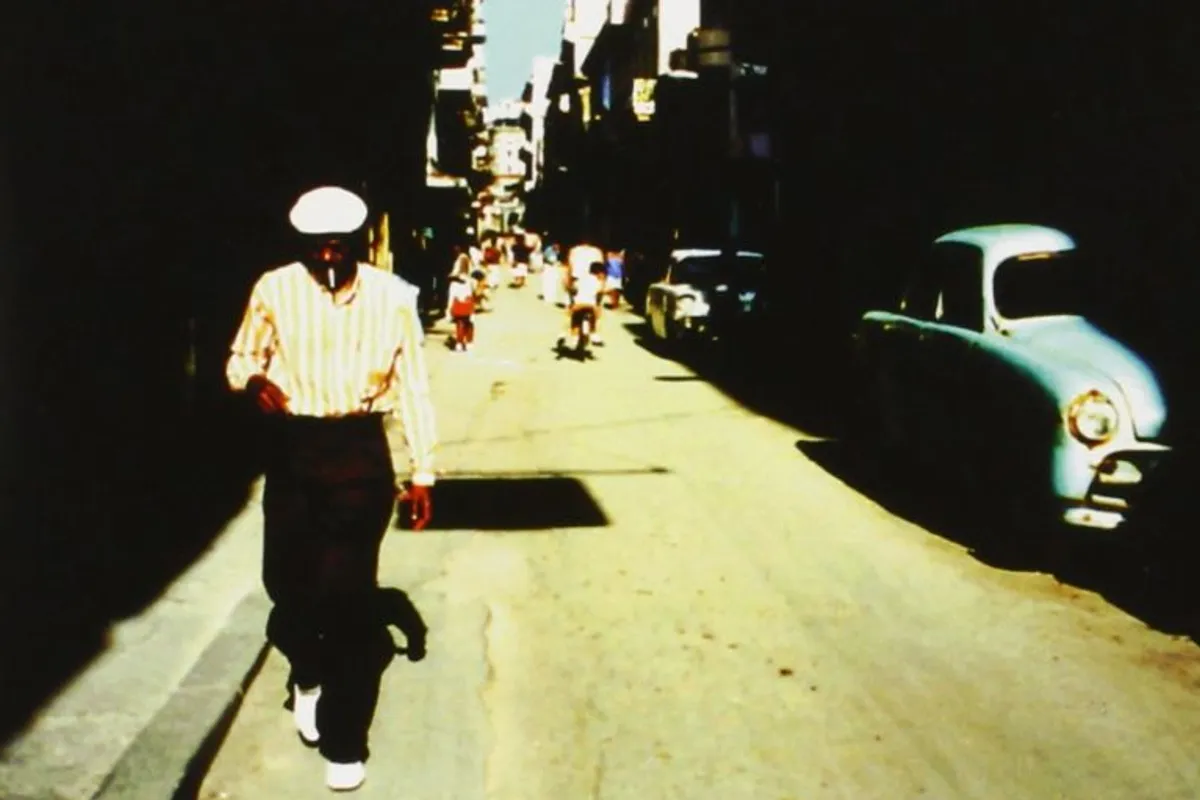 Official venue promotional image for the Buena Vista tribute, showing a man walking along a Havana street beside a vintage car.