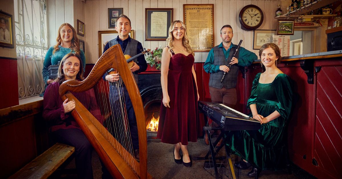 Official Irish Christmas in America ensemble photograph with harp, fiddle, flute and keyboard