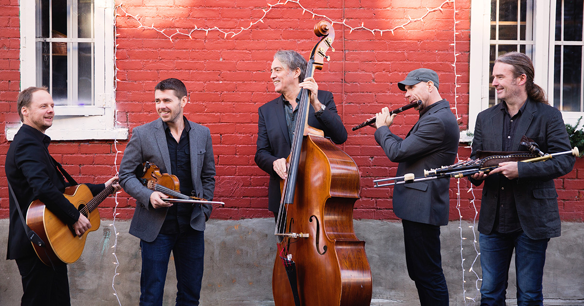 Date-free official Lúnasa band photograph with guitar, fiddle, double bass, flute and pipes