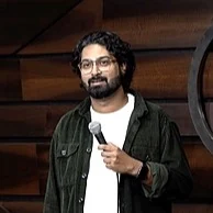 Ravi Gupta holding a microphone