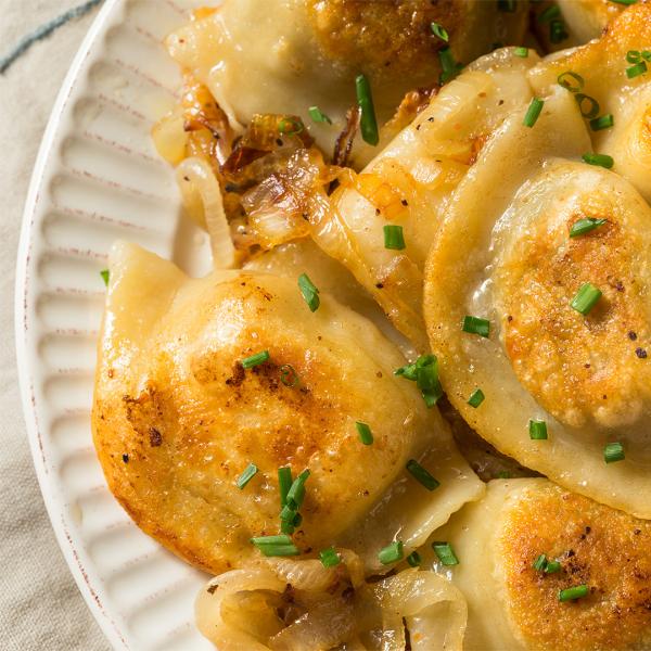 Official library event photograph of Polish dumplings with onions and herbs on a plate